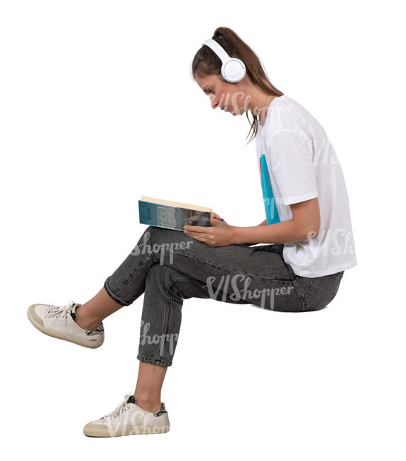 woman with headphones sitting and reading a book
