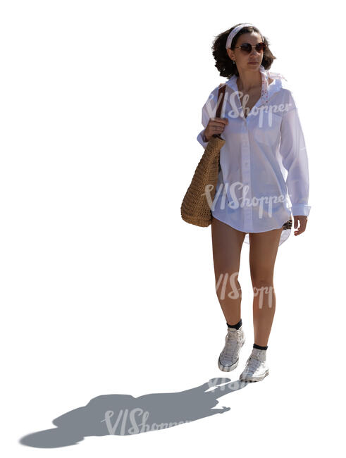 backlit woman in summer walking