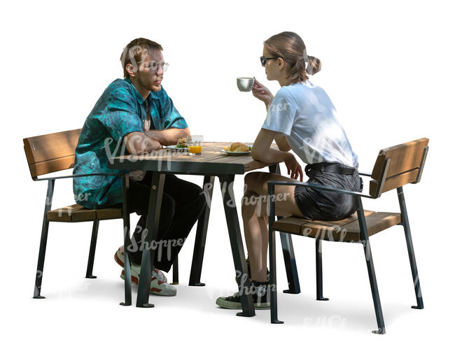 man and woman sitting in a partial shade and drinking coffee