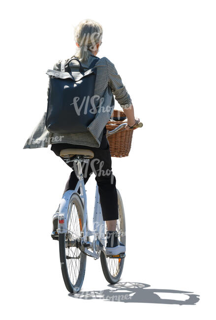 backlit woman with a backpack riding a city bike