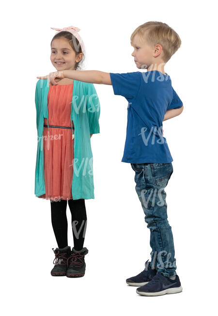 two kids standing and pointing at smth