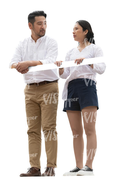 two asian people standing up on a balcony