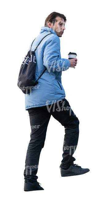 man with a coffee cup walking up the stairs
