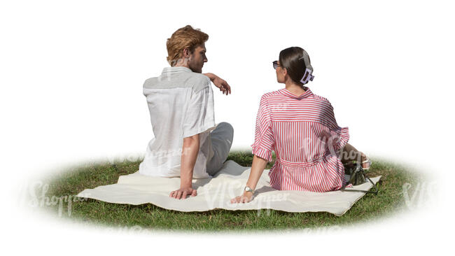 man and woman sitting on the grass