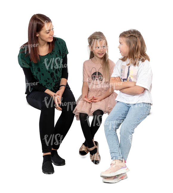 woman sitting and talking to two girls