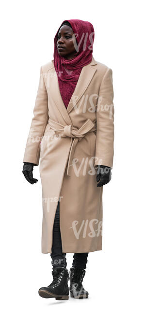 black woman wearing a camel overcoat walking