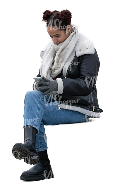 woman sitting outside in winter and texting