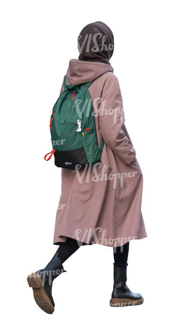 woman with a pink coat and green backpack walking