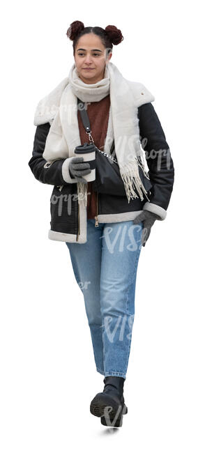 young woman walking in the street in winter and drinking coffee