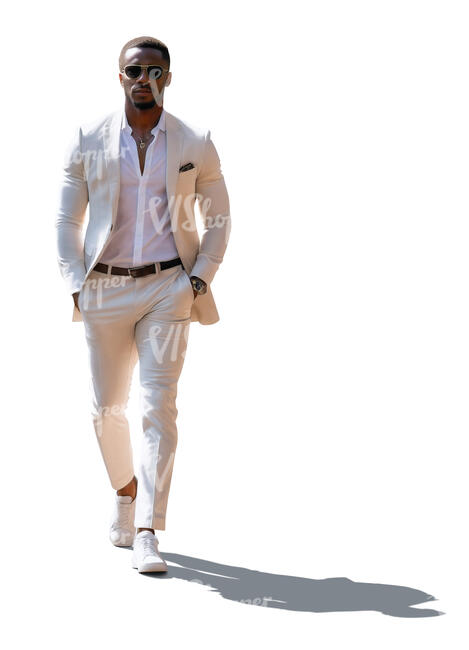 backlit black man in a white suit walking