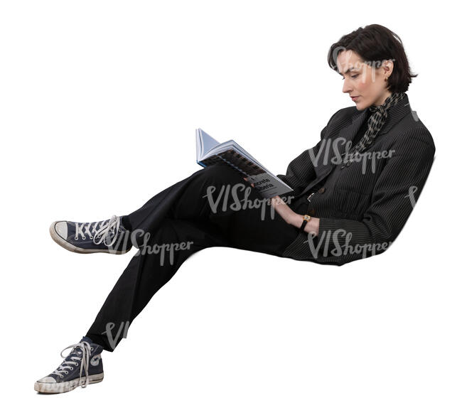 woman sitting on a sofa and reading a book