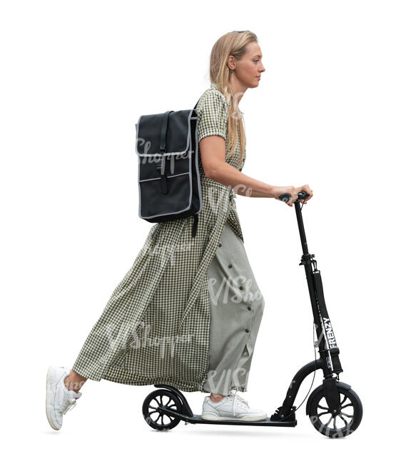 woman in a long summer dress riding a scooter
