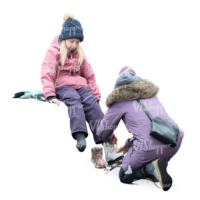 woman helping a girl to put skates on