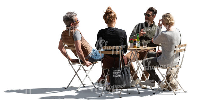 backlit image of a street cafe with group of people sitting