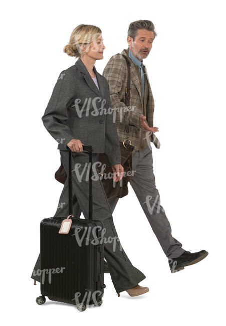 man an woman with suitcases and bags walking