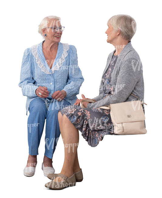 two cut out elderly ladies sitting and talking