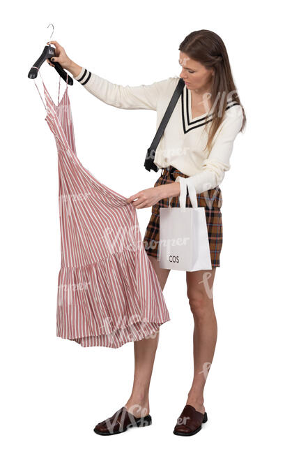 cut out woman in a shop picking a dress to buy