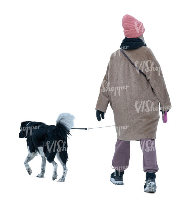 woman in winter walking a dog