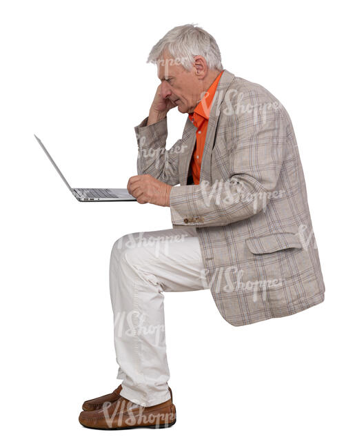 elderly gentleman sitting and working with laptop