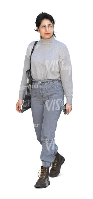 woman in grey sweater and jeans walking