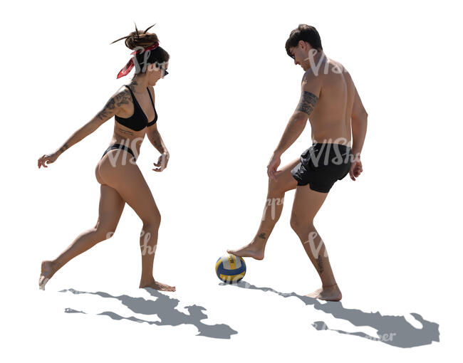 two people playing football on the beach