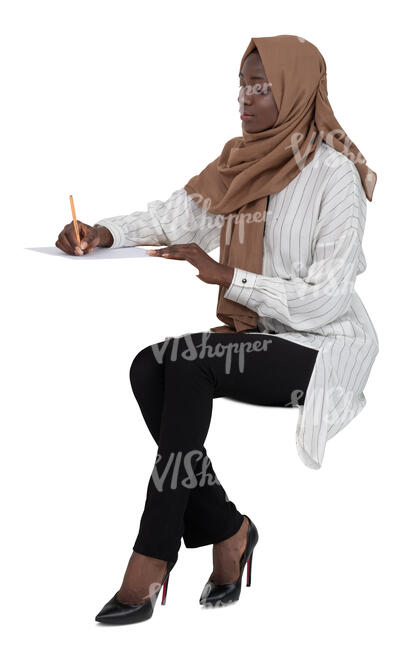 cut out muslim woman sitting behind the desk and writing