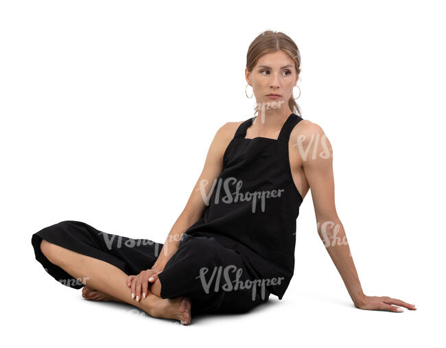 woman in black outfit sitting barefoot on the  ground