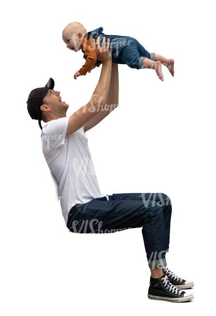 man sitting holding a baby up in the air 