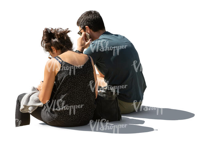 two cut out backlit people sitting