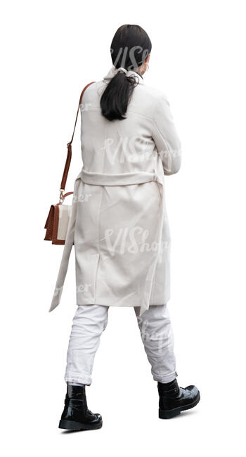 woman wearing a white overcoat walking