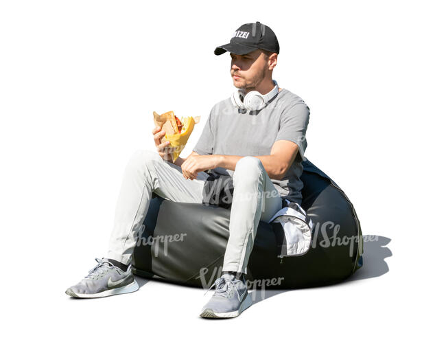 young man sitting and eating a hamburger