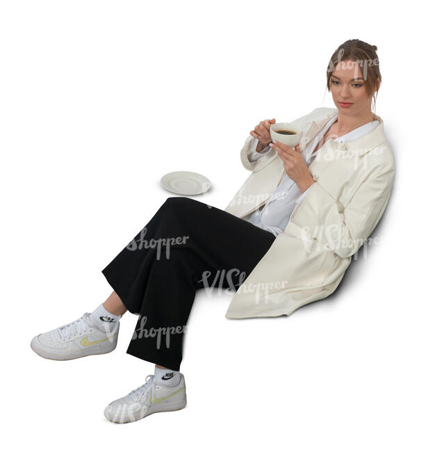 cut out woman sitting and drinking coffee seen from above