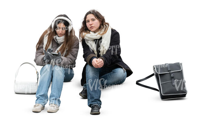 two women sitting outside in a colder weather