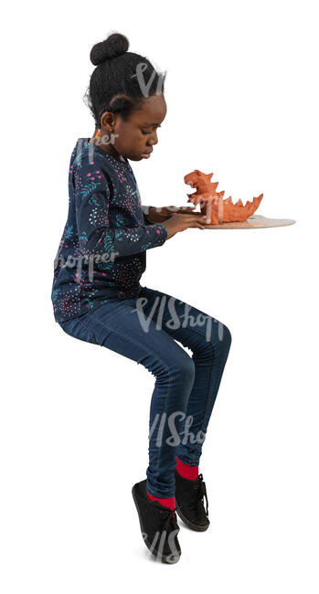 black girl sitting and doing ceramics