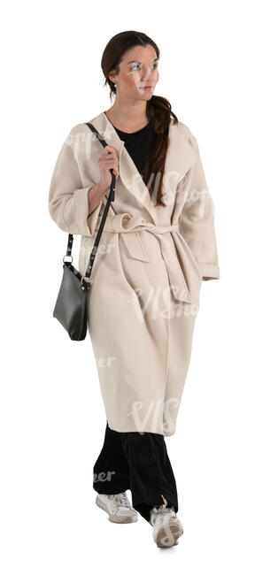 cut out woman in a white overcoat walking