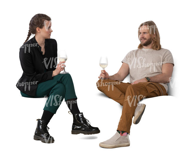 two people sitting on a sofa and drinking wine