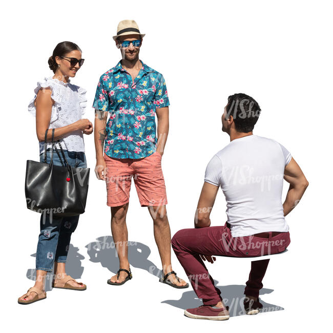 man sitting and talking to two friends standing