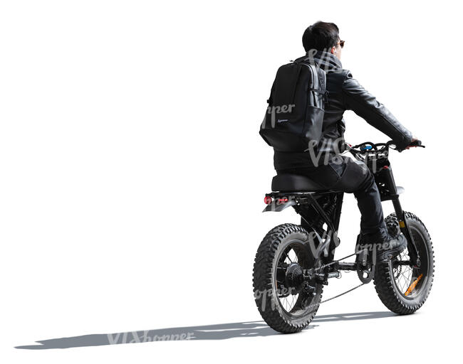 cut out backlit man riding an electric fat bike