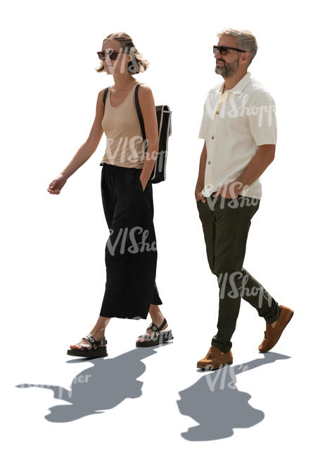 backlit man and woman walking