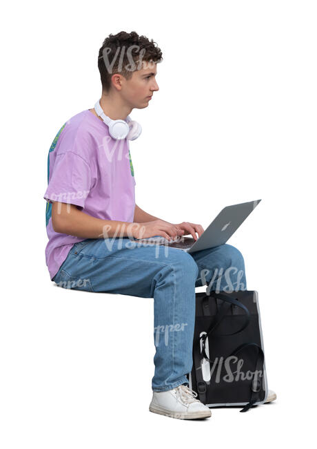 teenage boy sitting and working with computer