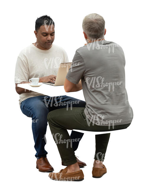 two men sitting behind the desk with computer and drinking coffee