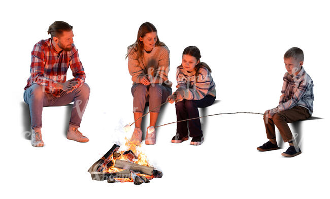 family sitting around a fire and cooking marshmallows