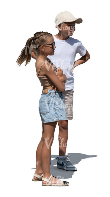 two children standing standing outside in the sun