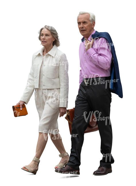 two older people in formal clothing walking