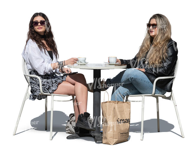 two women sitting in an outdoor cafe