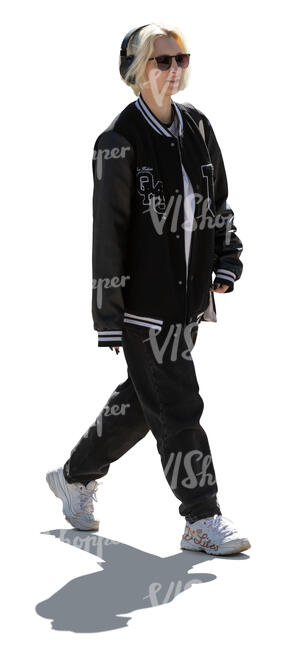 cut out backlit young woman with headphones walking