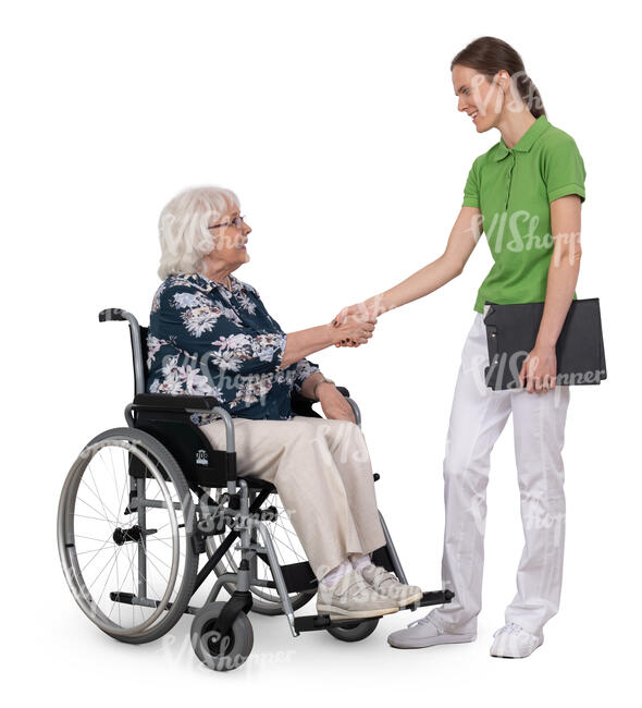 older woman in a wheelchair greeting a physical therapist