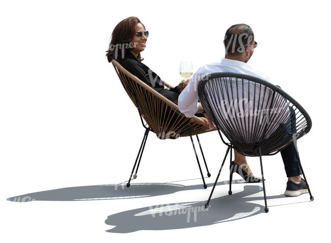 two cut out backlit people sitting in acapulco chairs and talking