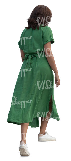 woman in a green dress walking up the stairs
