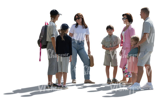 backlit group of adults and children standing
